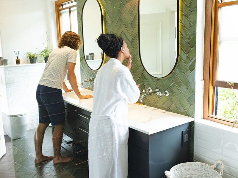 A Diverse Couple In A Bright Bathroom